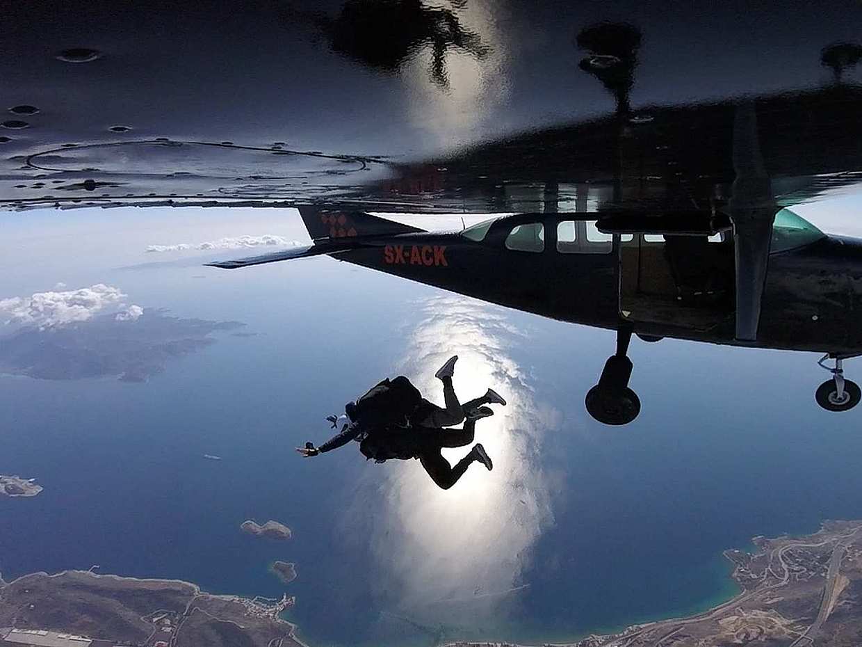 Tandem skydiver descending near Kopaida airfield outside Athens