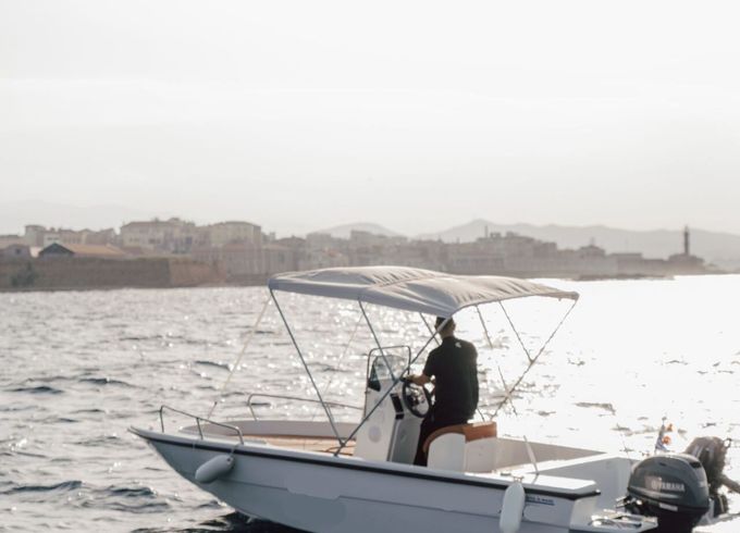 Guest steering the self-drive Kreta Mare motorboat off Chania